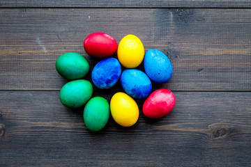 Traditional easter design with colorful eggs on wooden background top view space for text