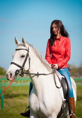 Obraz premium Woman sitting horse. Day. Full height. Red leather jacket