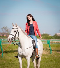 Fototapeta premium Woman sitting horse. Day. Full height. Red leather jacket