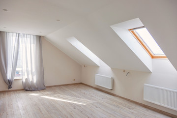 A window in the attic. Sunny morning. Light in the window.