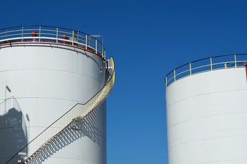 Oil storage tanks, stairs and blue sky