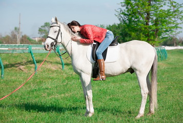  Woman sitting  horse. Day. Full height. Red leather jacket