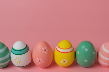 Colorful easter eggs on pink background. Easter concept.