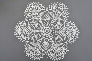 Crocheted lace napkin home decoration on gray