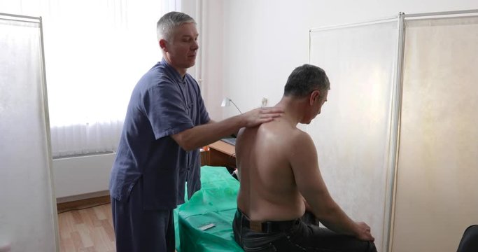 the doctor treats the man of the patient with Chinese medicine