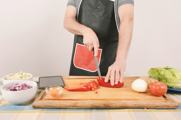 Close up of man cutting vegetables on the board