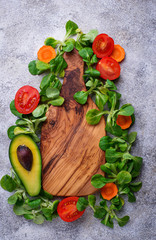 Green food background with corn lettuce, tomato and avocado