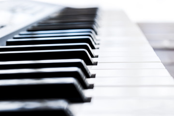 Side view of piano keys. Close-up of piano keys. Close frontal view. Piano keyboard with selective...