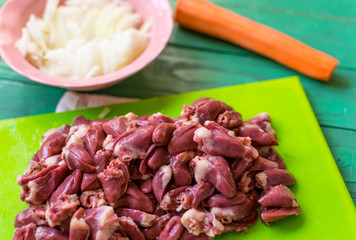 Fresh raw chicken hearts cut for preparation.