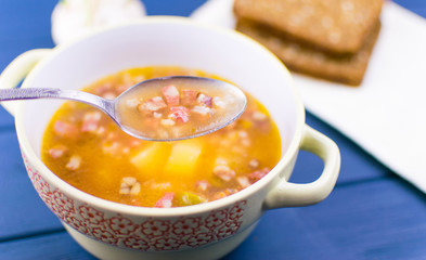 Soup of saltwort. Soup from different types of sausages, olives, potatoes, tomato paste.