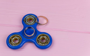 Two wedding rings on the spinner. The concept of the game in a relationship.