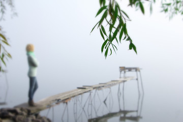 travel meditation reflection thought woman wooden bridge river sunrise fog