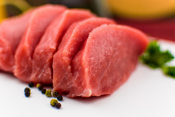 Pork fillet chopped on a white background.