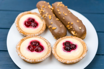 A set of different cakes on a white plate.