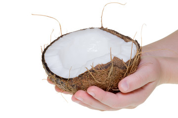 Human hand holding a half of coconut isolated on a white background in the studio