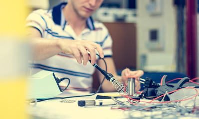 Electrician soldering wires.