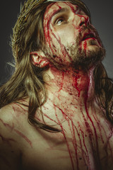 Religion, representation of the Calvary of Jesus Christ on the cross. Holy Week in Spain. man with...