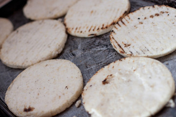 Concept: Latin American family cooking and eating together. Traditional Colombian plain and white arepas. Breakfast or dinner with homemade typical arepas. Tradition food.