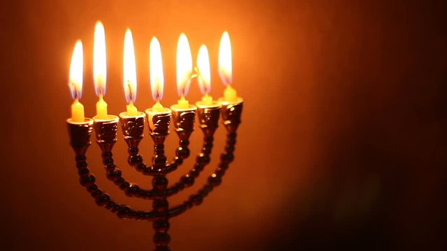 Flame of menorah on the dark background