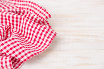 
Red tablecloth in a cage on a wooden table