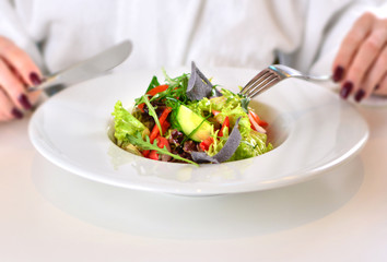 Macro of a healthy vegetables and greens on a white plate. Healthy lifestyle starts with a healthy food. We are what we eat concept.