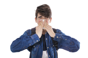 child or young boy sneezing with isolated handkerchief on white background