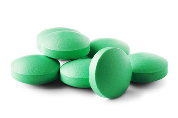 Heap of medical pills in green color on isolated white background. Concept of healthcare and...