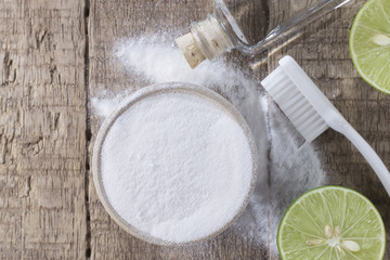 baking soda and lemon on wooden table