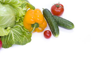 Green cabbage. Yellow pepper. Red tomatoes and cucumbers on a white background.