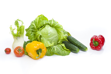 Fototapeta na wymiar Green cabbage. Yellow pepper. Red tomatoes and cucumbers on a white background.