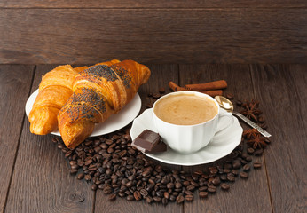 A Cup of coffee with fresh croissants .