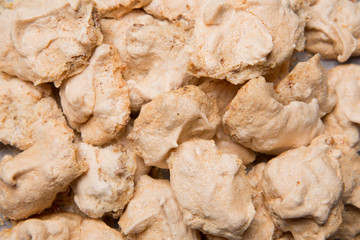 traditional home made meringues, authentic recipe with nuts, on parchment paper