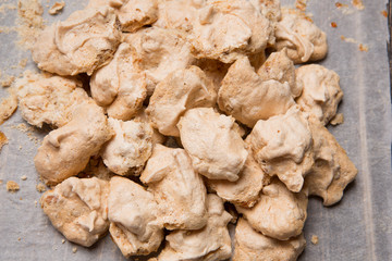 traditional home made meringues, authentic recipe with nuts, on parchment paper