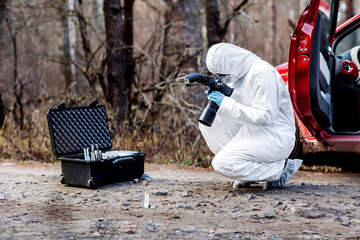 expert collecting evidence at the crime scene. Law and police concept