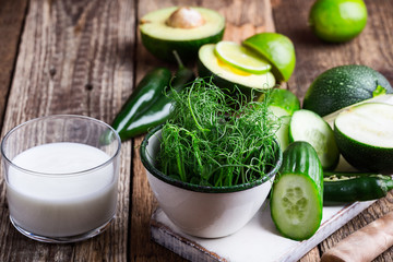 Green pear sprouts, fresh vegetables and yogurt for healthy meal