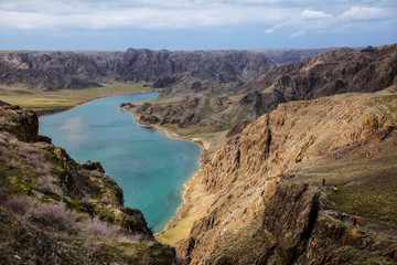 A beautiful, turquoise river flowing through a deep gorge. Ili river in spring. Kazakhstan.