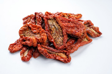 Traditional Italian antipasto dried tomatoes as close-up on white background – covered