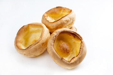 Traditional English Yorkshire pudding as close-up on white background – covered