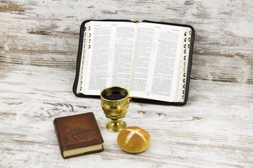 Сhurch participles and a cup of wine on the background of the Bible