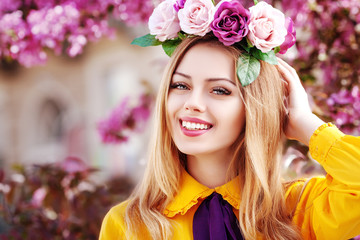 Outdoor close up portrait of young beautiful happy smiling girl posing in spring street with...
