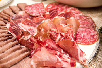 Meat and sausage sliced on a plate