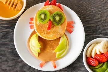 Cute owl homemade pancake with fruits for kids breakfast