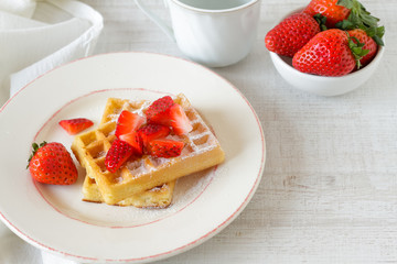 Healthy breakfast table with belgian waffles,  fruits and coffee