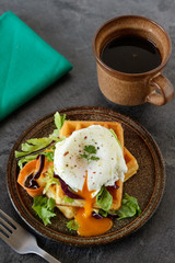 Savory belgian waffles with salad and poached egg