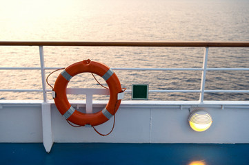 Buoy or lifebuoy ring on shipboard in evening sea in miami, usa. Flotation device on ship side on seascape. Safety, rescue, life preserver. Water travel, voyage, journey. Wanderlust, vacation, trip