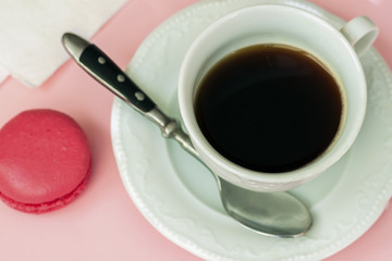 Pink macaron, macaroon and cup of coffee. Romantic morning. Top view. Dessert, gift, present for beloved