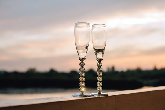 Beautiful champagne glasses on a sunset background.