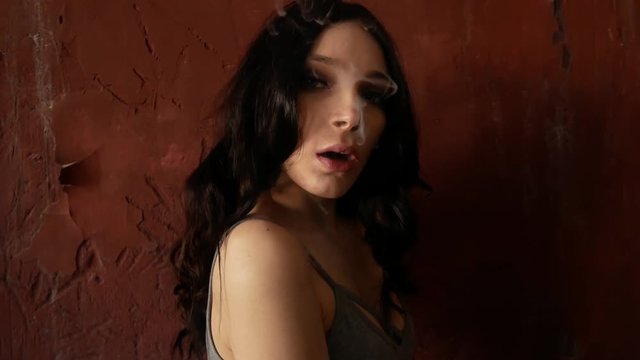 Close up of woman mouth smoking. The girl slowly and sexually releases smoke from an electronic cigarette