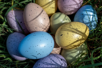 Colorful Easter eggs on the grass in sunny day. Easter concept.