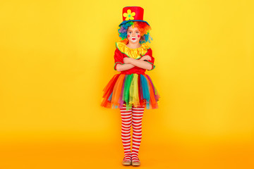 Full height little clown, crossed hands and have bad mood